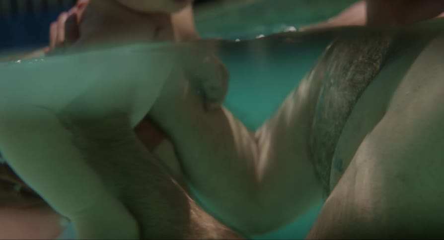 Father and son swim in the pool on a hot summer day
