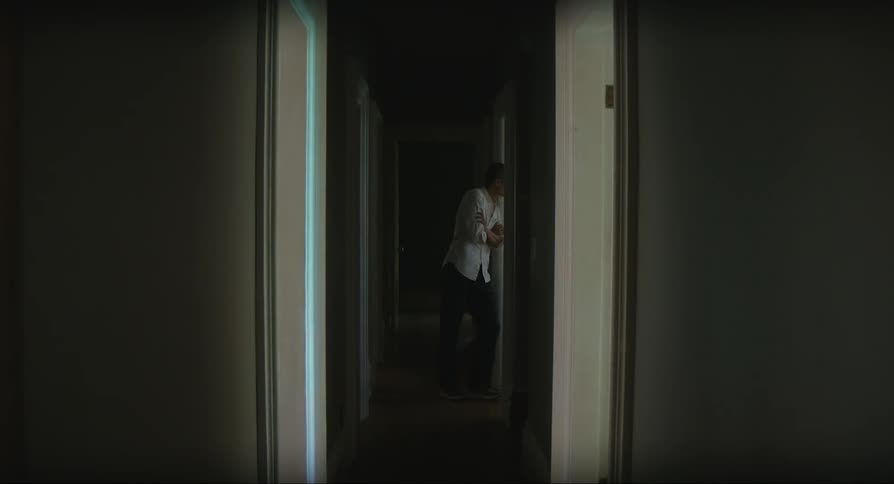 Man leaning against the door of a room