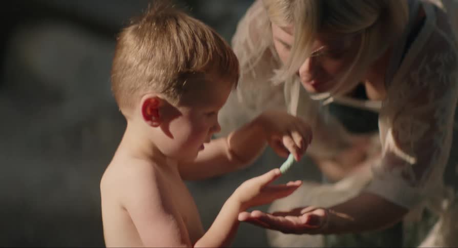 Mother and son interact with caterpillar