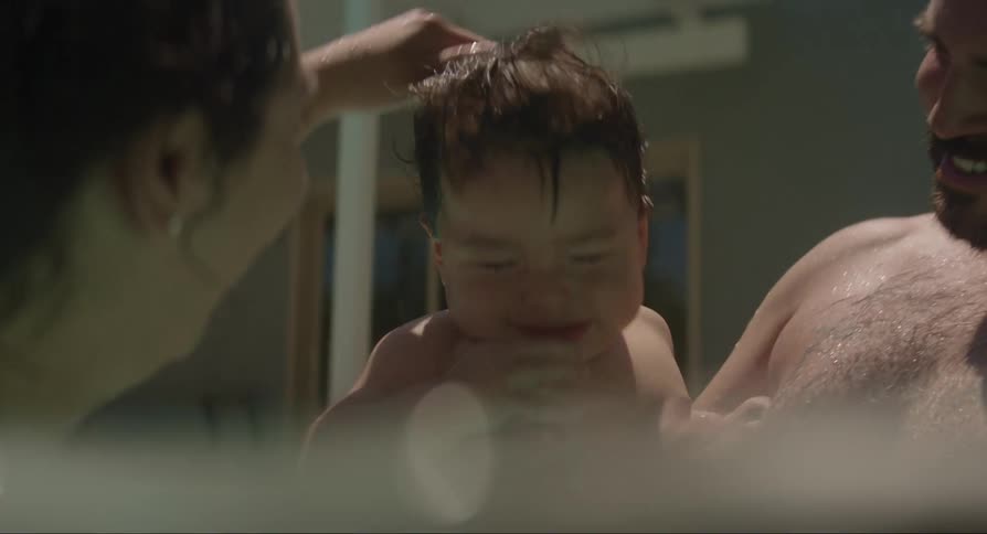 Parents playing with their baby son in the pool