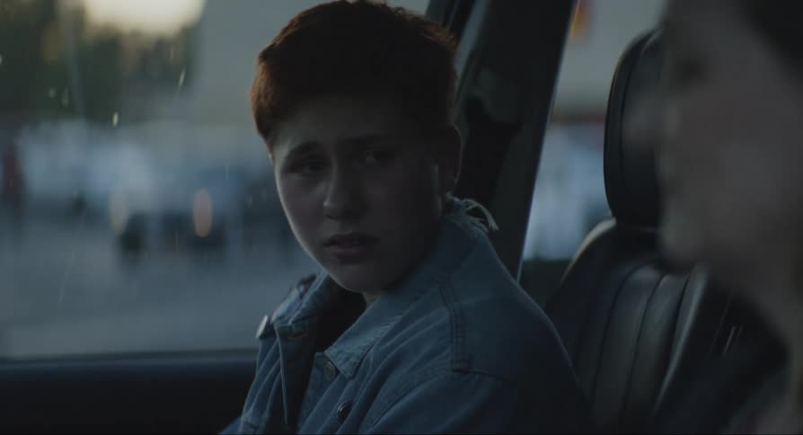 Mother talking to her son inside the car then they hug each other