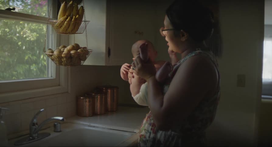 Mother kissing her babys feet in the kitchen