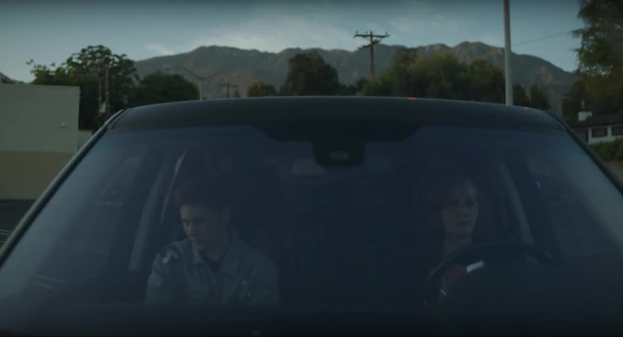Mother having an argument with her son on a car parked outdoors
