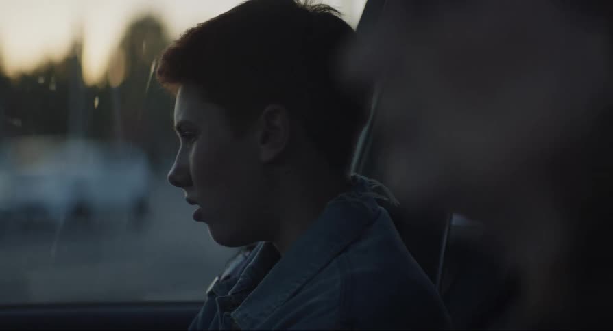 Boy sitting next to his mother inside the car with a sad facial expression