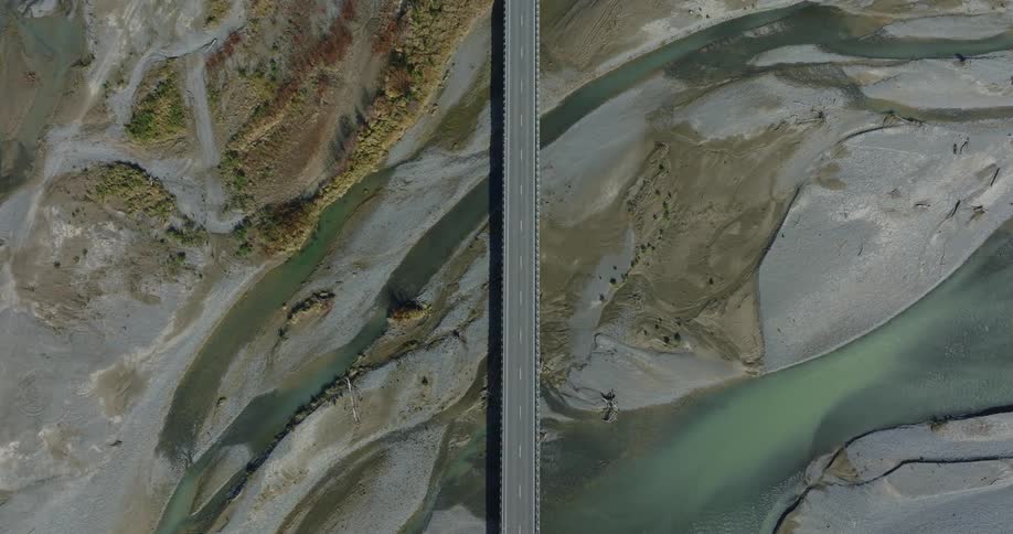 Top down aerial of an elevated road over the marsh