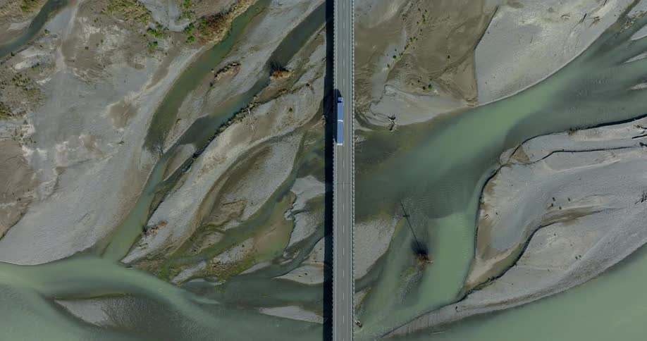 A bridge with a highway over a small river