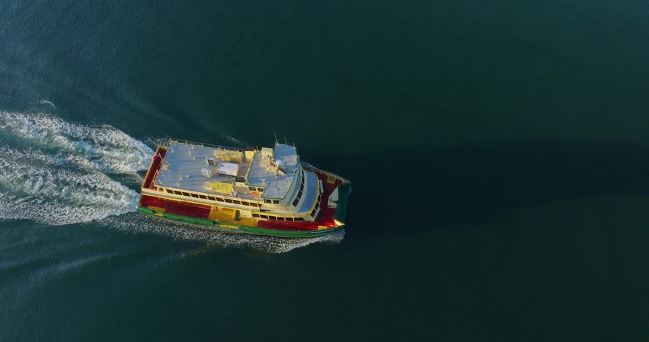 A small boat sailing on the water and making ripples on the surface