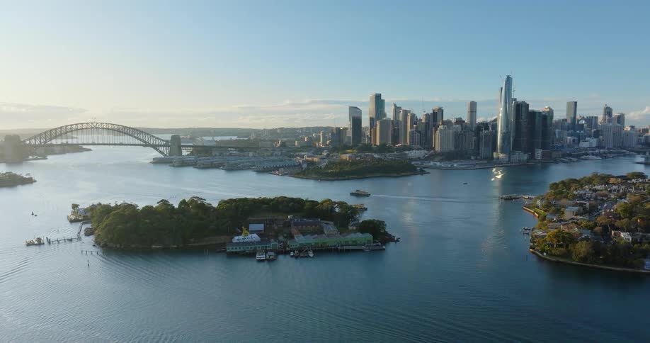 Aerial view of a coastal metropolis with small islands boats and a bridge