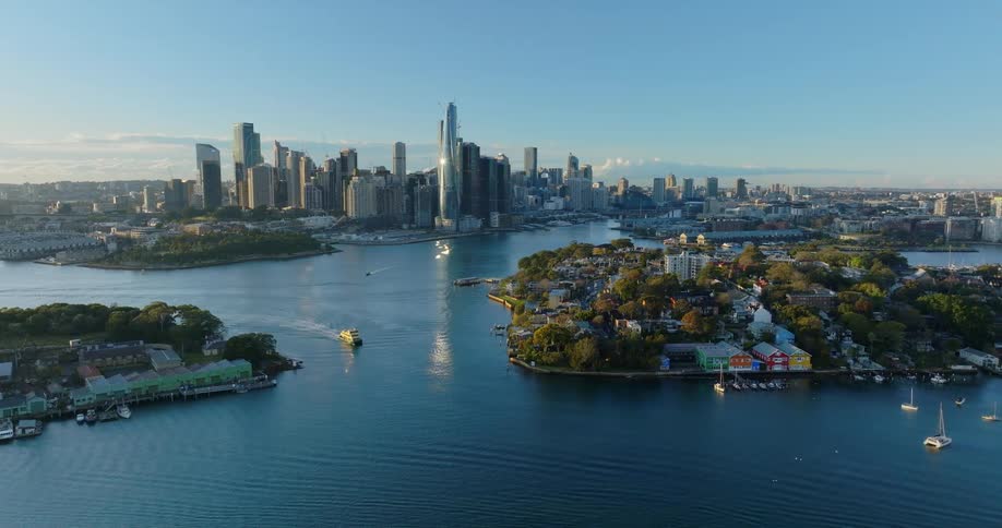Aerial view flying towards barangaroo the rocks and the city cbd with goat island in the middle of sydney harbour
