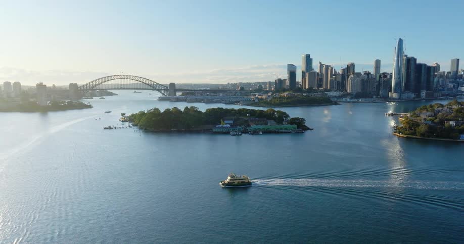 A boat sailing in a sea with many islands and a city in the background
