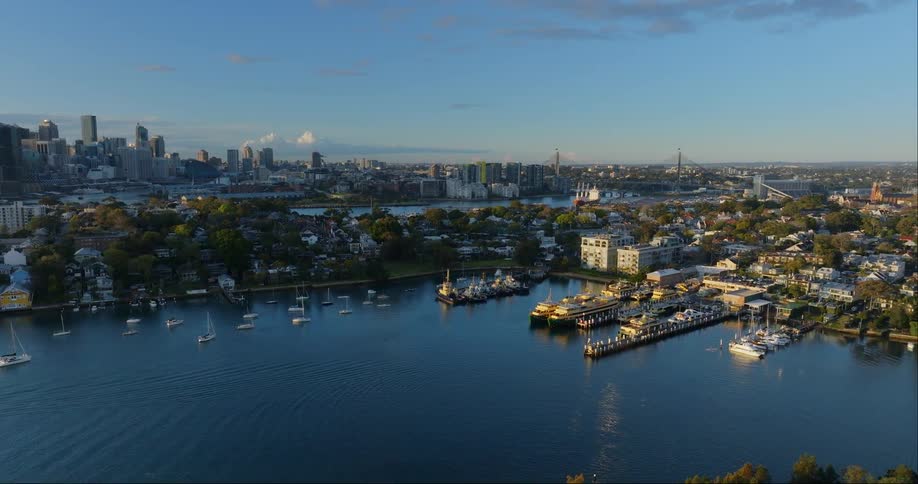 Aerial view of boats in the harbor surrounded by buildings and the urban skyline