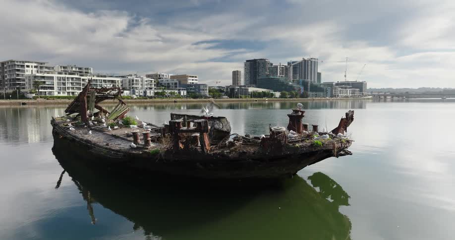 A ship is wrecked by the shore of the city
