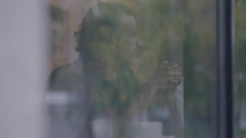 Man chewing food and then picking up a book