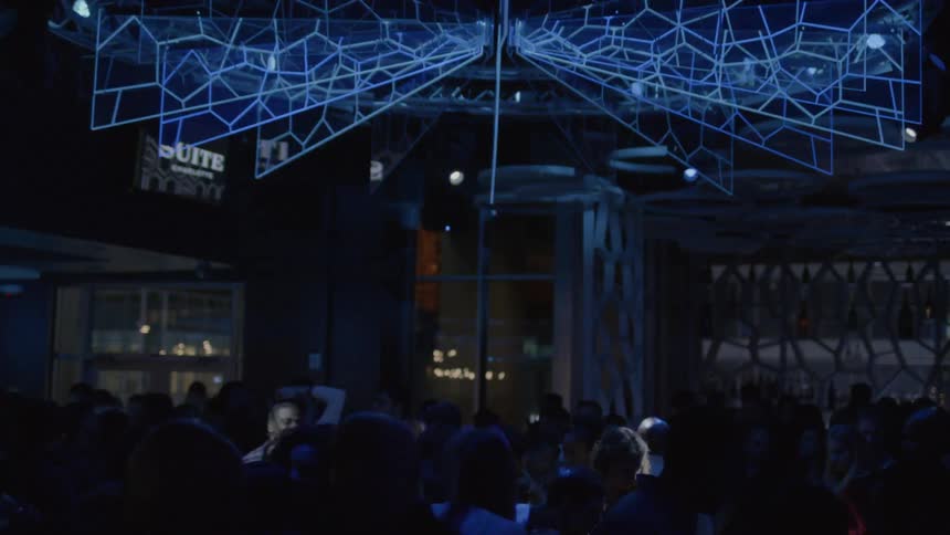 Lights blinking from above over a crowded club