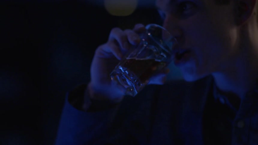 People are sitting in a club having drinks and talking