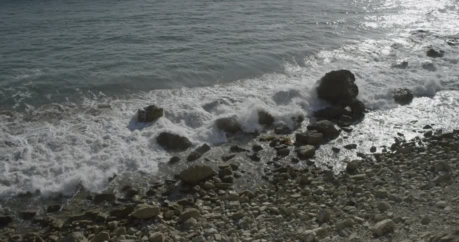 Waves coming ashore on a rocky beach