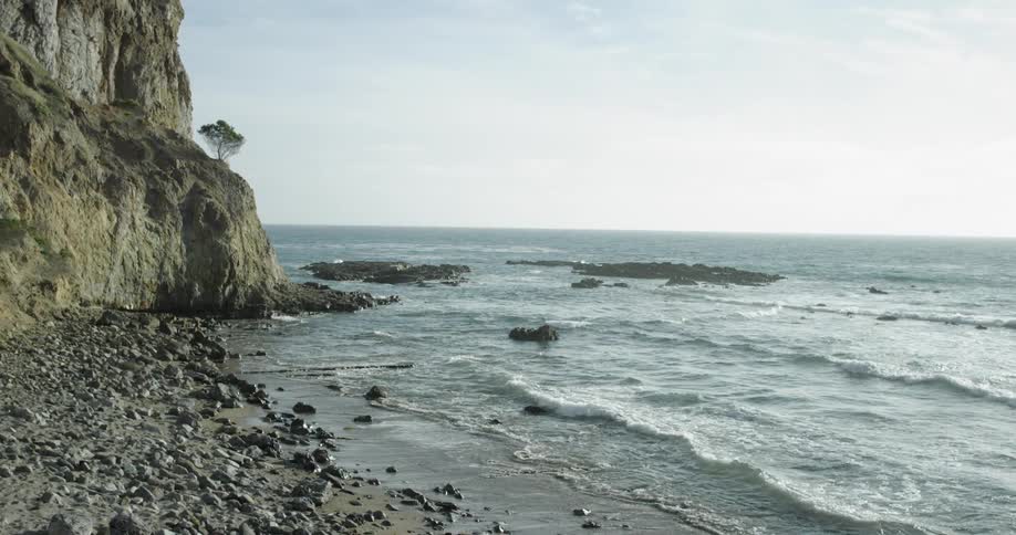 Waves crash against the rocky shore
