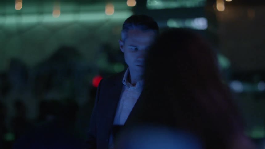 Man talks to someone at a nightclub