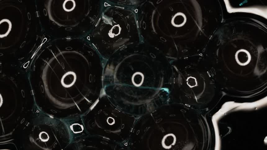 Circles with water and a black background