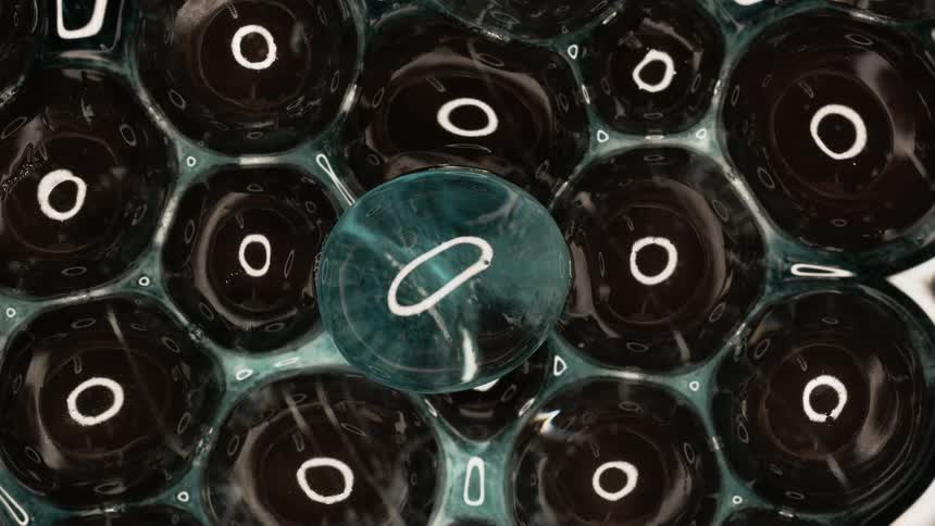 Abstract balls with internal black and transparent liquid in motion