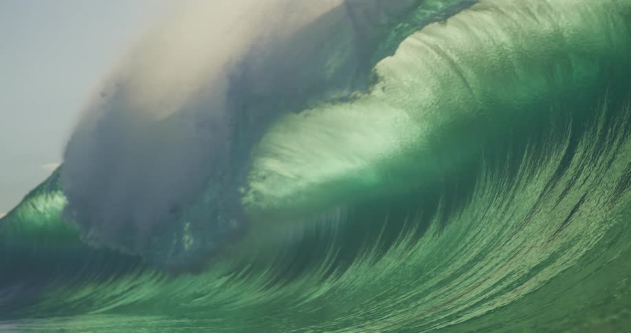 A large wave crashes in the ocean