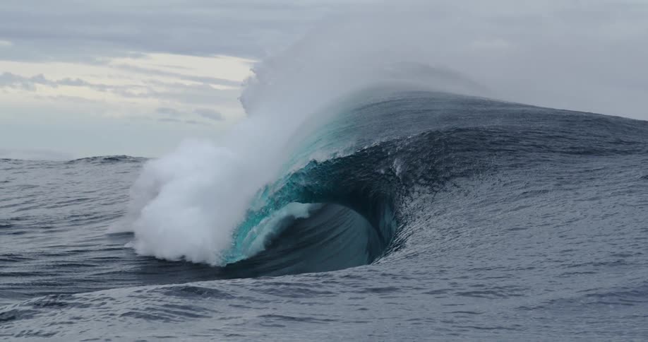 Waves crashing into the ocean with no land in sight outdoors during day time