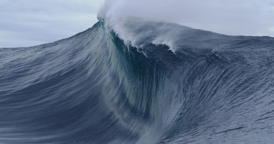 A large wave crashes in the ocean