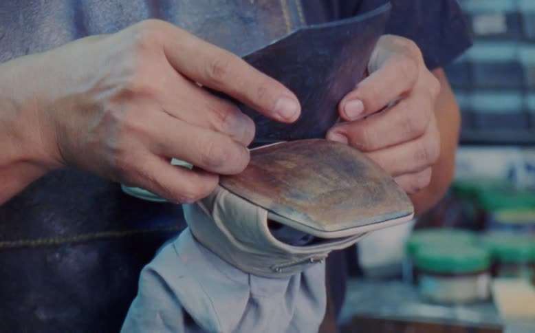 Hands of a carpenter crafting a womens footwear