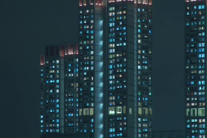 Building lights on a tower block turning on during the night