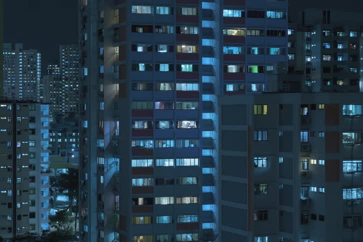 City buildings illuminated by window lights