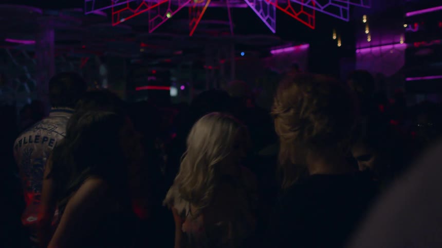 People dancing on the dance floor of a club