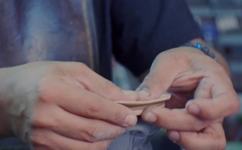 A shoemaker repairing a sole