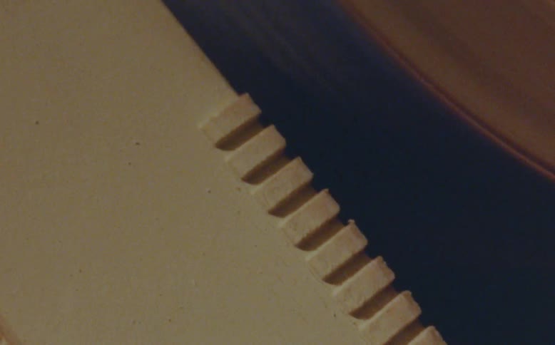 Roller of a manufacturing machine in motion