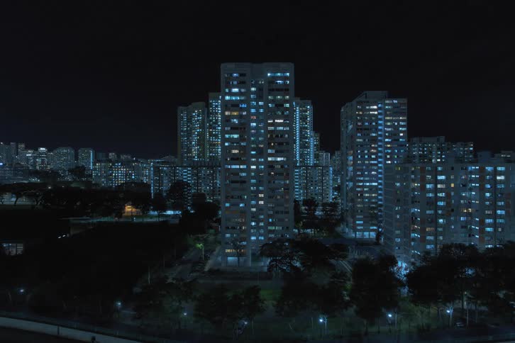 Building lights throughout the city turn on as night passes