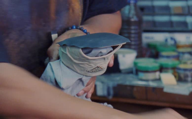 Man making a female shoe in a workshop
