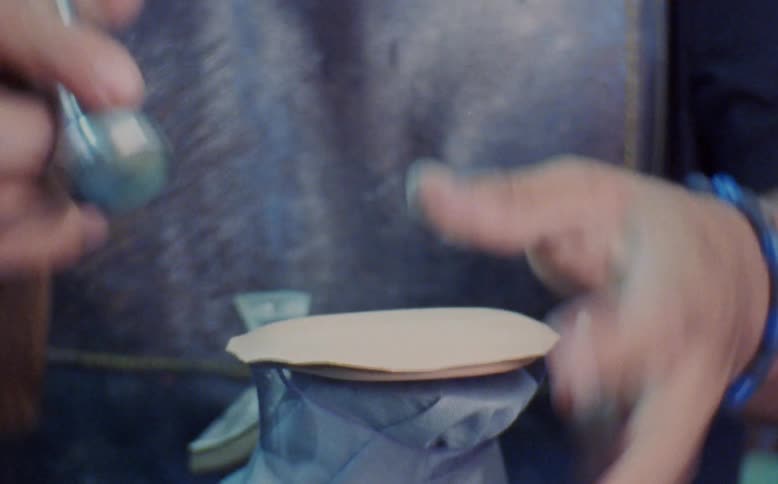 Closeup of a human hand using a hammer and manufacturing a womens high heel
