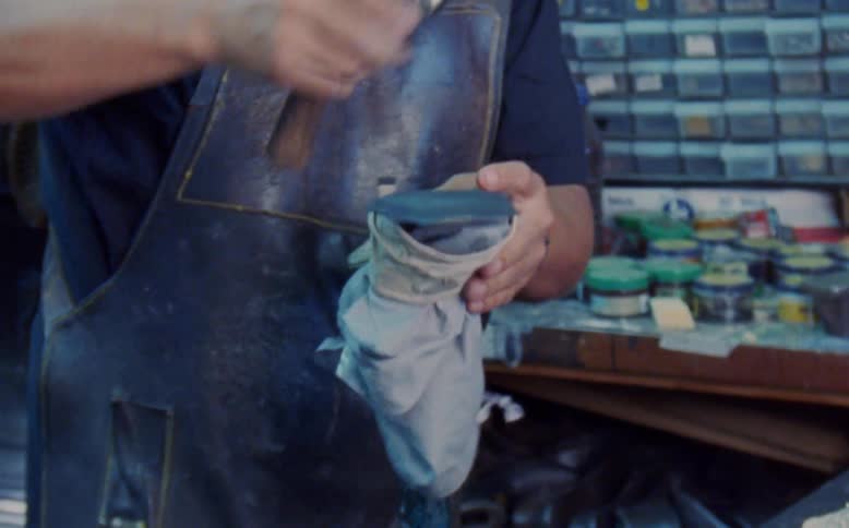 Craftsman hammers the sole of a shoe