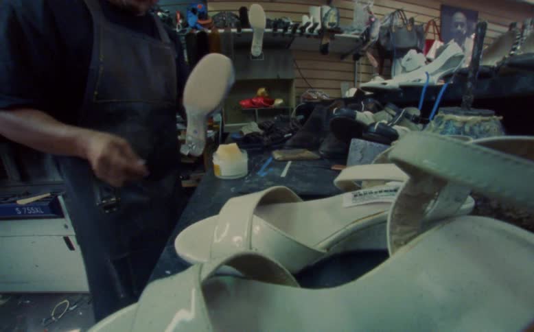A shoemaker producing shoes in a factory