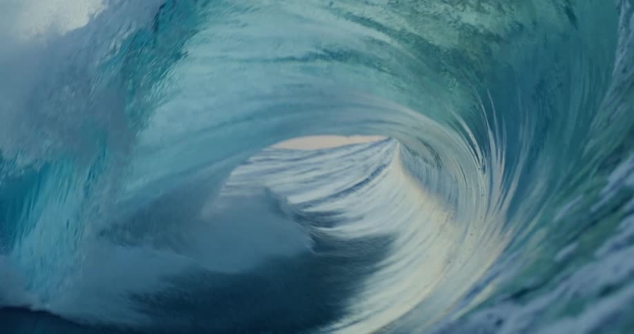 A large wave crashes in the ocean