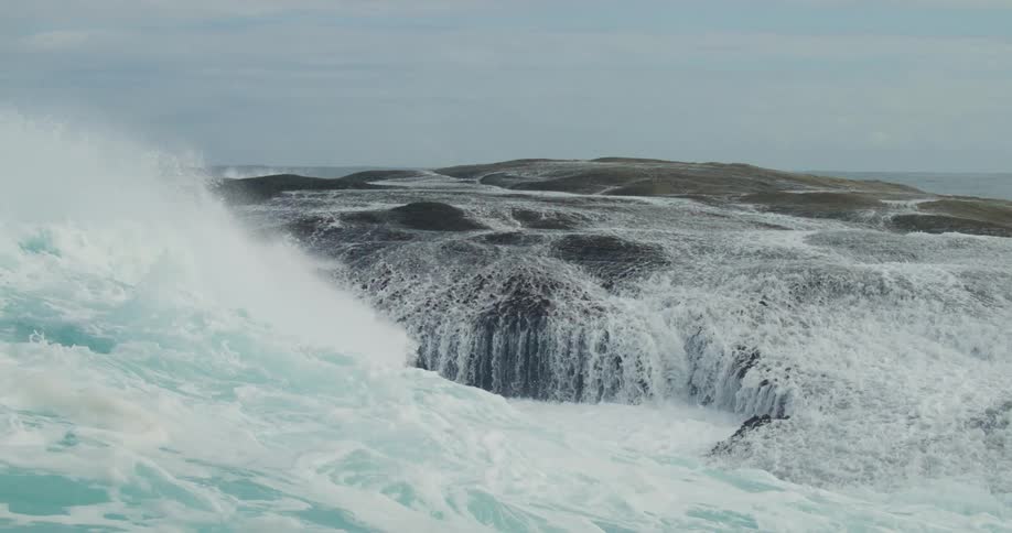 Sea with furious waves crashing on the shore of the beach