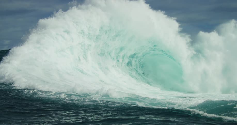 View of a massive wave in motion generating a lot of foam and power