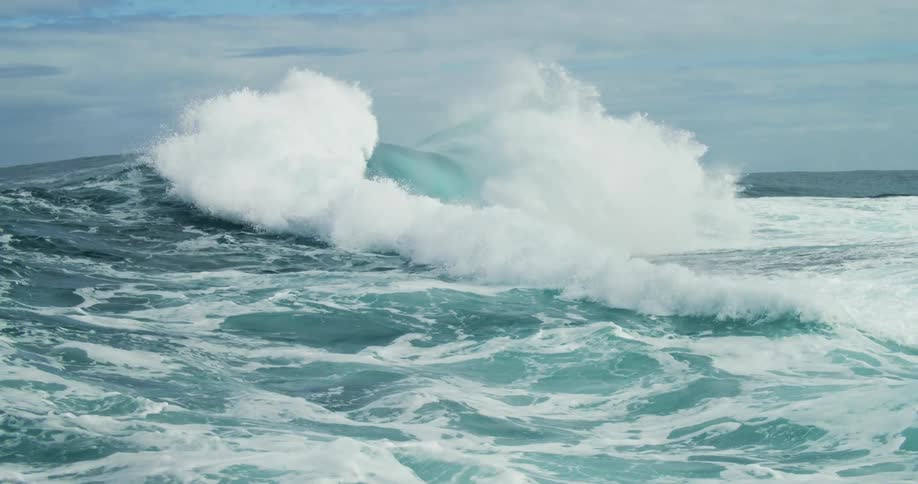 The waves crash together from both sides