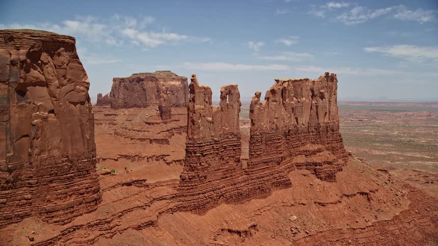 Approaching towering desert buttes in Monument Valley Utah Arizona during a sunny day