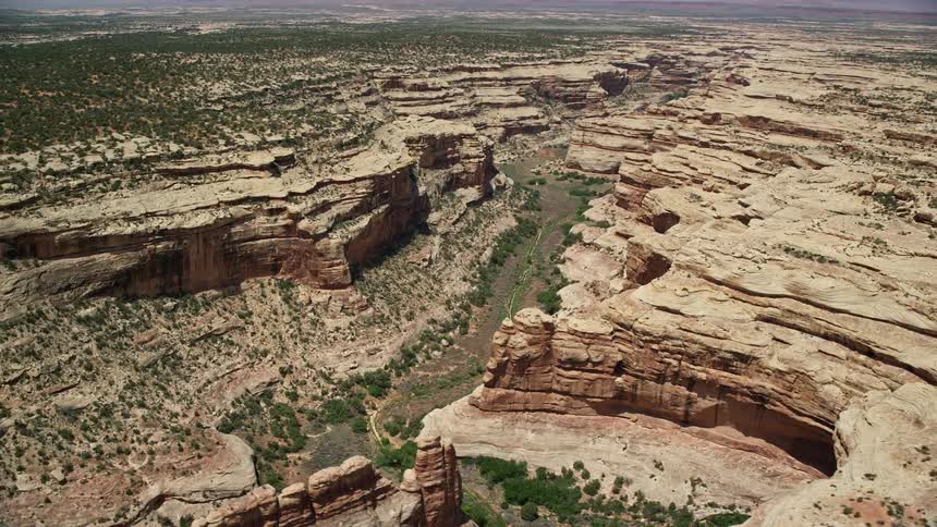 A stunning aerial view of the Grand Gulch canyon in the arid sunny landscape of Southwest United States