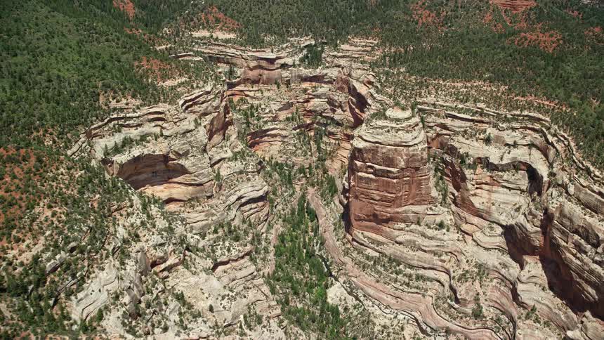  aerial footage of flying through a picturesque box canyon with towering cliffs in Manti-La Sal National Forest Utah on a sunny day