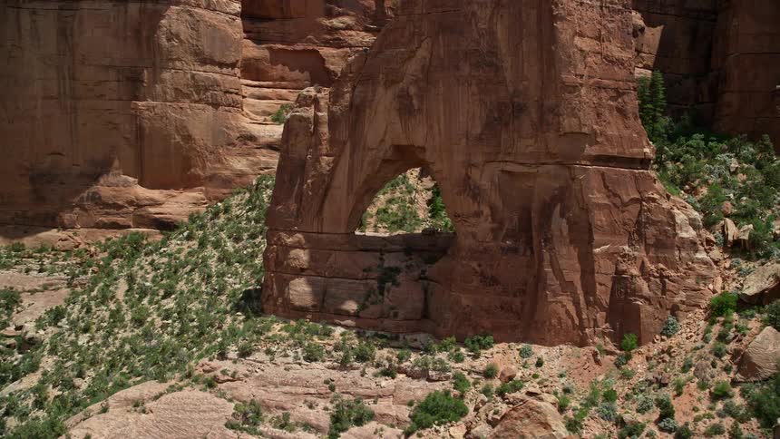 Aerial footage showcasing the stunning Cathedral Arch in Arch Canyon Utah with breathtaking views of rock formations and the surrounding canyon