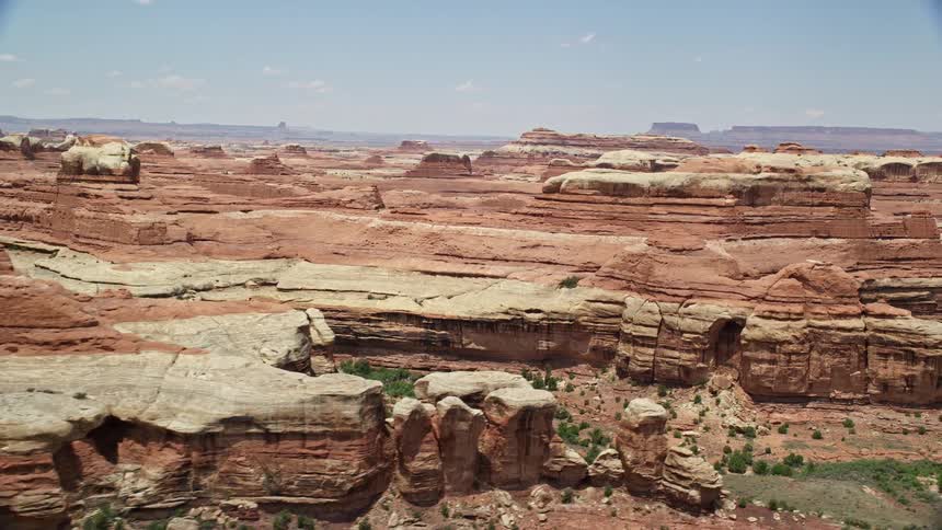 Passing through narrow canyons and red rock walls this aerial footage captures the stunning desert landscape of Canyonlands National Park in Utah