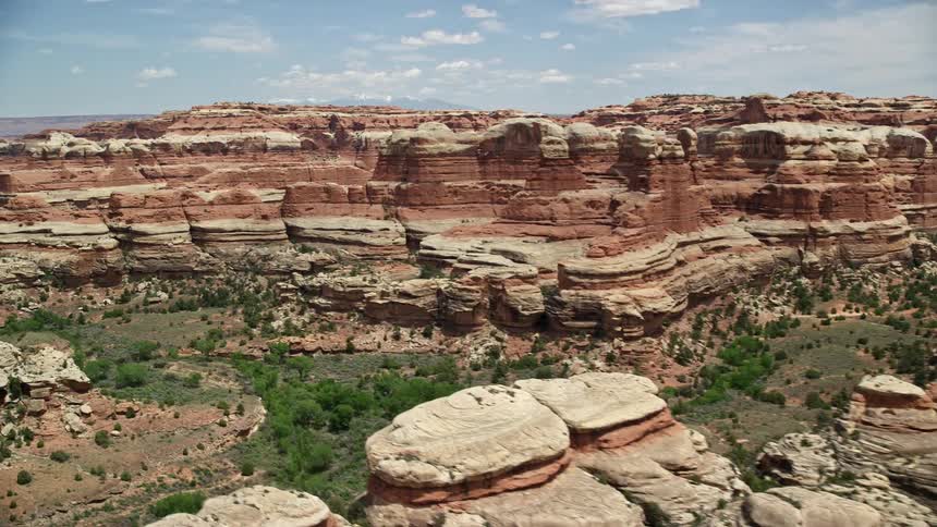 Tilt and fly over stunning rock formations and desert canyons in Canyonlands National Park Utah capturing the arid beauty of the Southwest United States during spring/summer