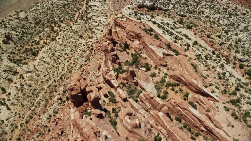an aerial view of the desert cliffs in Eagle Park Arches National Park Utah captured from a bird's eye perspective