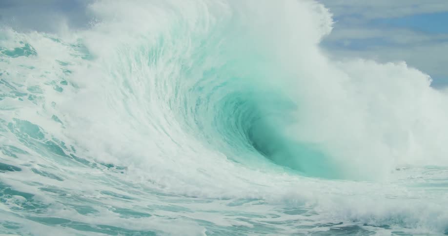 A big wave in the sea breaking and lifting water upwards